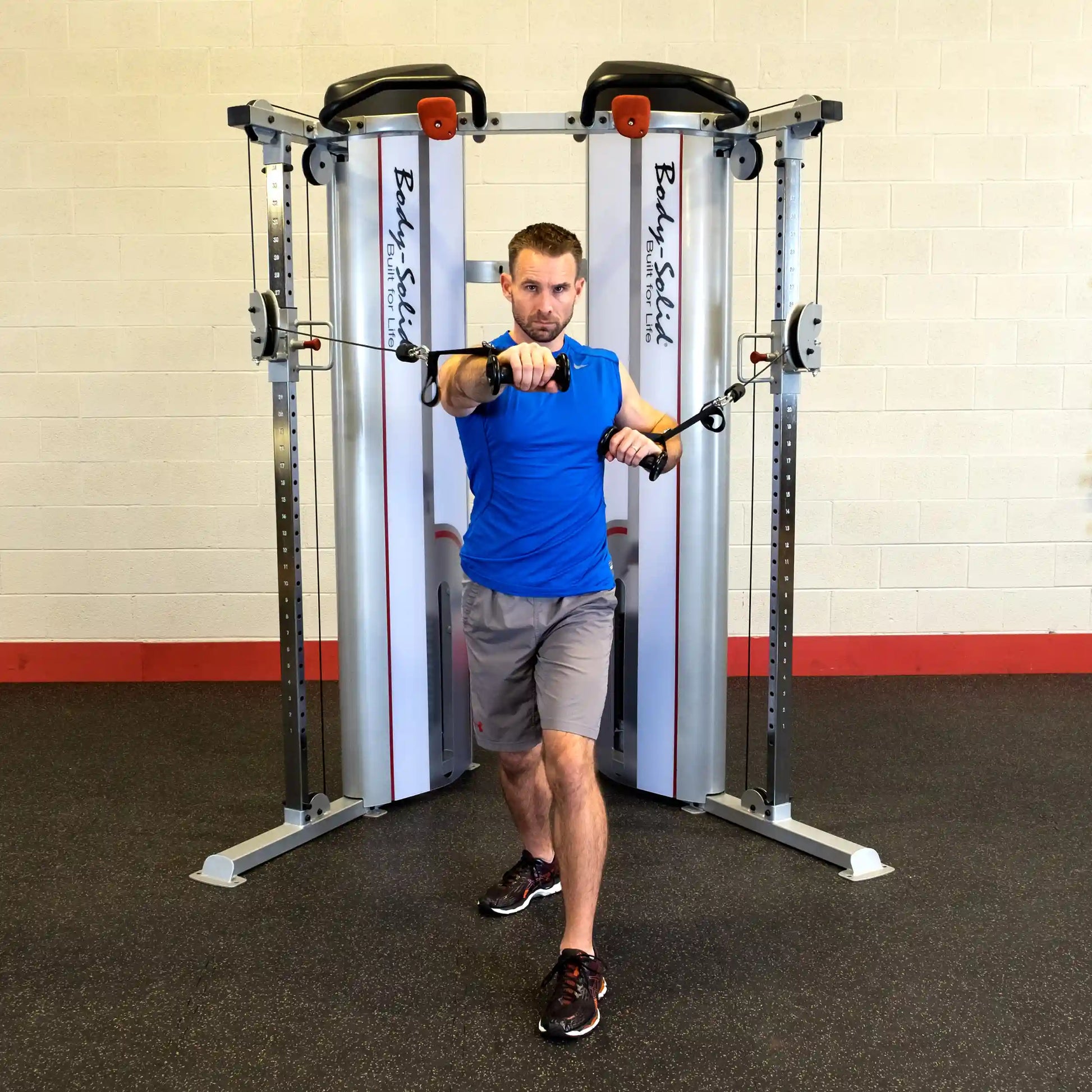 A man performing an exercise using the Body-Solid Pro ClubLine Series 2 Functional Trainer S2FT, showcasing a cable workout in a gym setting.