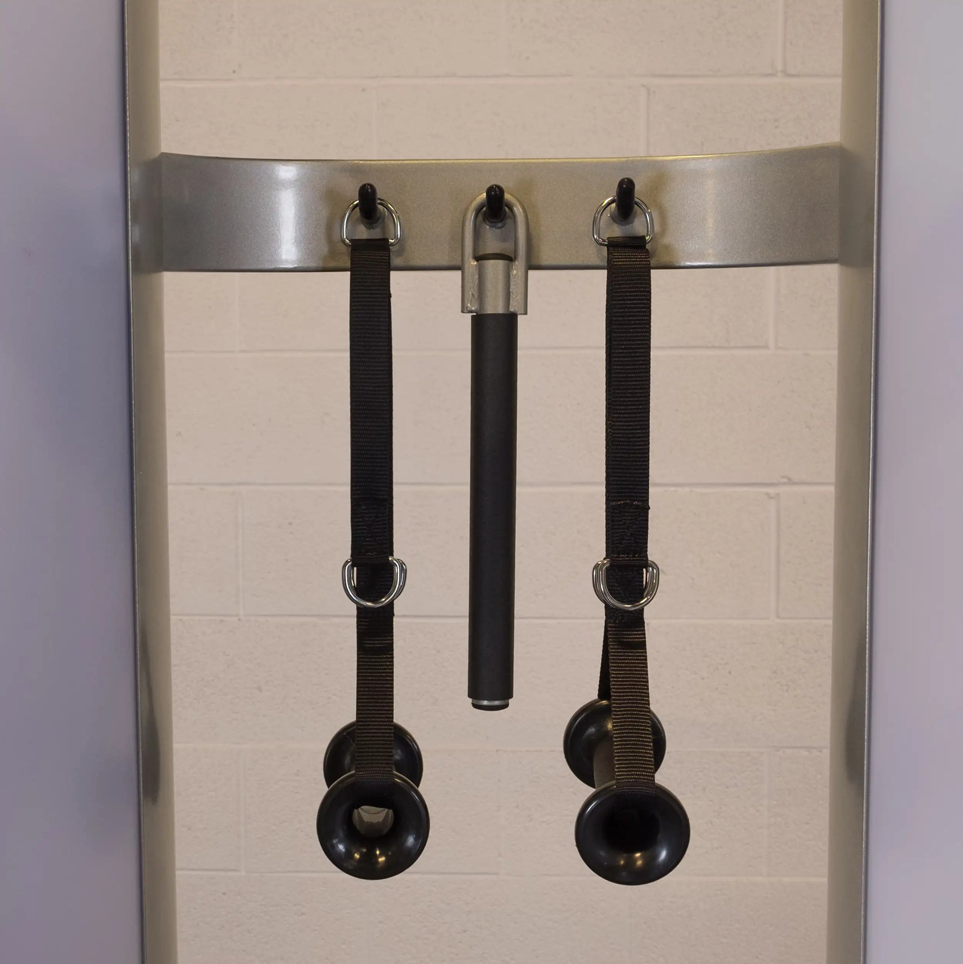 Close-up of the Body-Solid Pro ClubLine Series 2 Functional Trainer S2FT, featuring straps and handles for various workout routines, mounted on a wall.