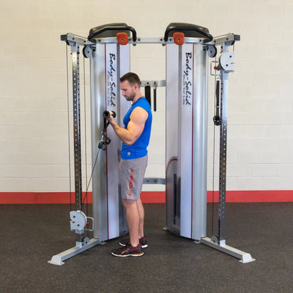 A person using the Body-Solid Pro ClubLine Series 2 Functional Trainer S2FT in a gym setting, demonstrating a workout with the cable machine.