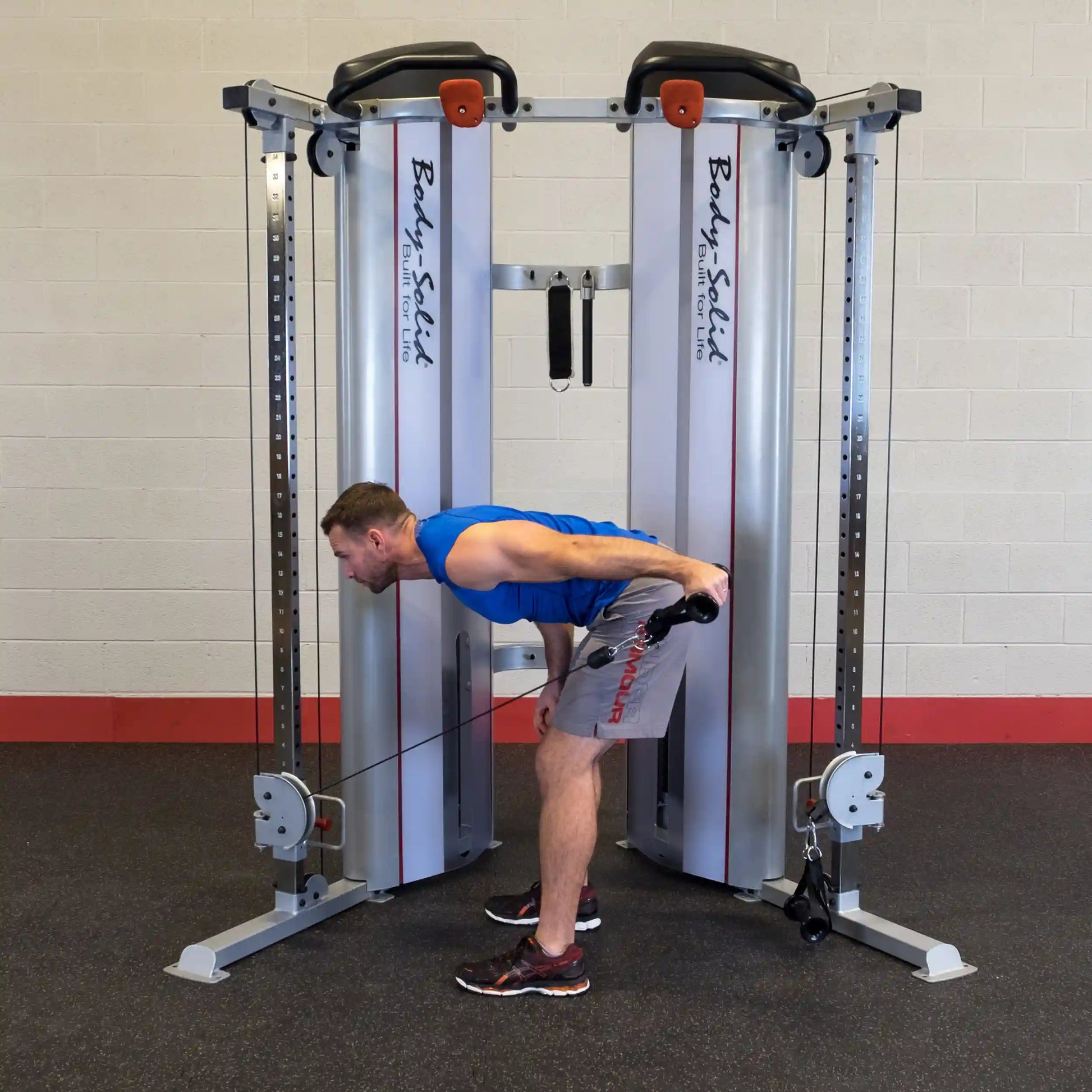 A person performing a bent-over row exercise using the Body-Solid Pro ClubLine Series 2 Functional Trainer S2FT in a gym setting.