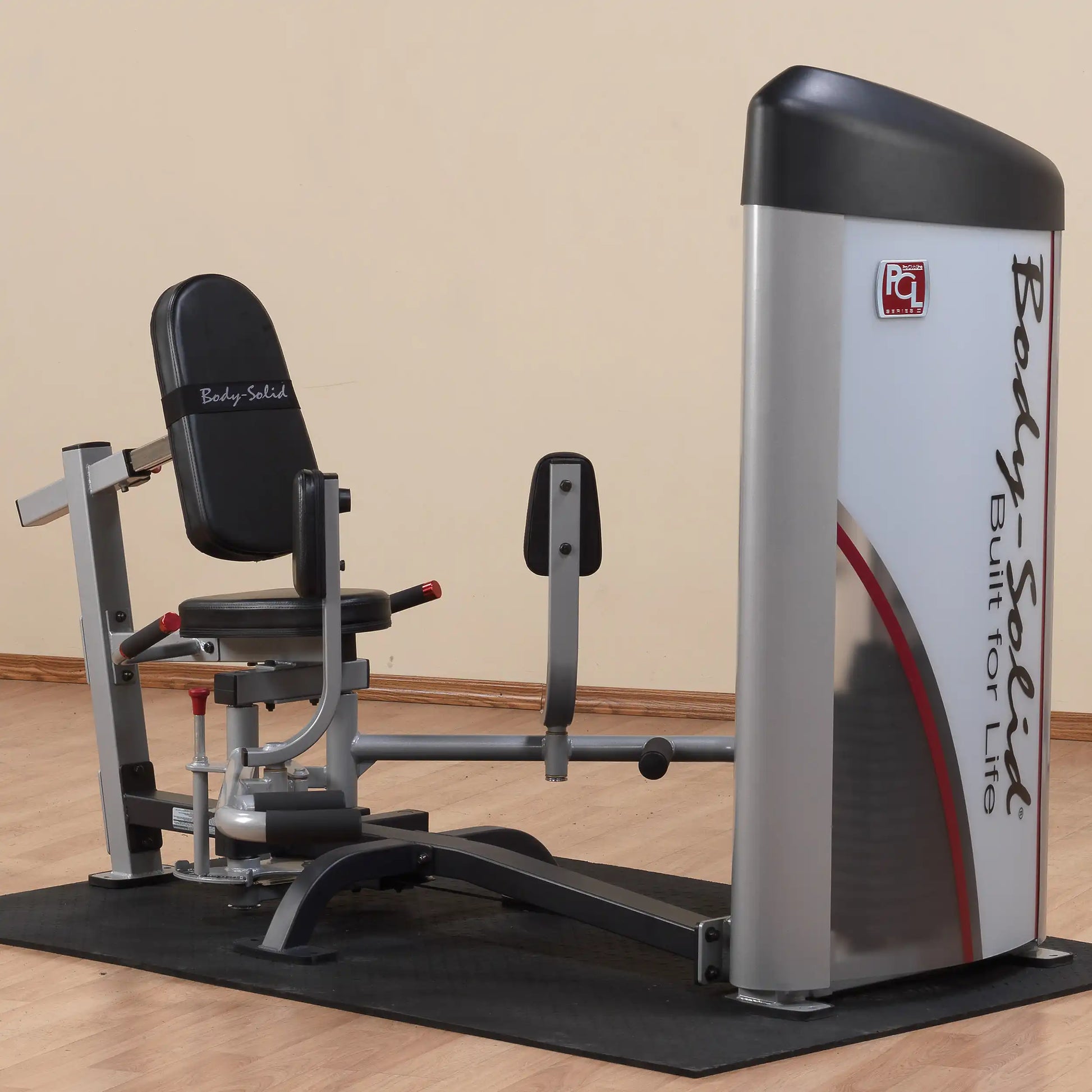 Body-Solid Pro ClubLine Series 2 Inner & Outer Thigh Machine S2IOT, featuring an adjustable seat and leg pads, set on a rubber mat in a gym environment.