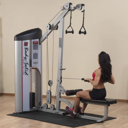 A woman using the Body-Solid Pro ClubLine Series 2 Lat Pulldown & Seated Row Machine S2LAT, performing a seated row exercise in a gym setting.