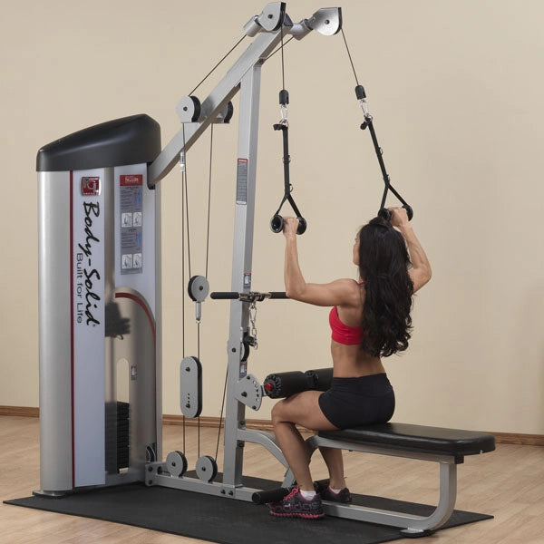 A woman using the Body-Solid Pro ClubLine Series 2 Lat Pulldown & Seated Row Machine S2LAT in a gym setting, performing a seated row exercise.