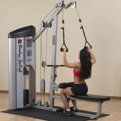 A woman using the Body-Solid Pro ClubLine Series 2 Lat Pulldown & Seated Row Machine S2LAT in a gym setting, performing a seated row exercise.