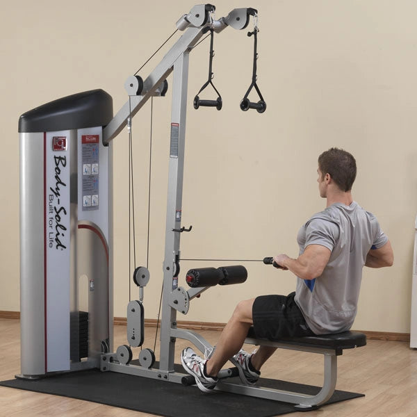 A person using the Body-Solid Pro ClubLine Series 2 Lat Pulldown & Seated Row Machine S2LAT in a gym setting, performing a seated row exercise.