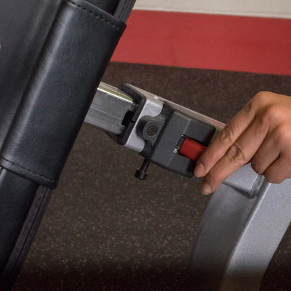 Close-up of a hand adjusting the lever on the Body-Solid Pro ClubLine Series 2 Leg Extension & Leg Curl Machine S2LEC.