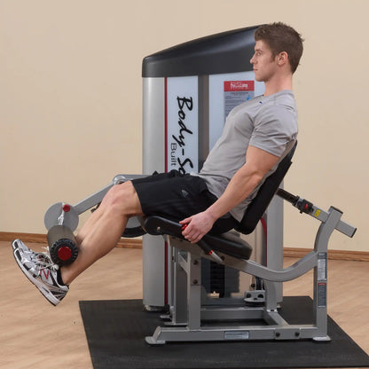 A person using the Body-Solid Pro ClubLine Series 2 Leg Extension Machine S2LEX, seated with legs extended, in a fitness setting.