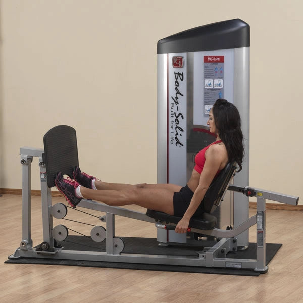 A woman using the Body-Solid Pro ClubLine Series 2 Leg Press & Calf Raise Machine S2LPC in a gym setting, demonstrating proper leg press form.