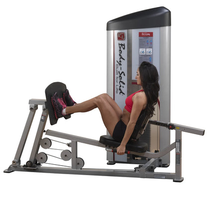 A woman using the Body-Solid Pro ClubLine Series 2 Leg Press & Calf Raise Machine S2LPC, demonstrating leg press exercise with a focused expression, wearing athletic attire.