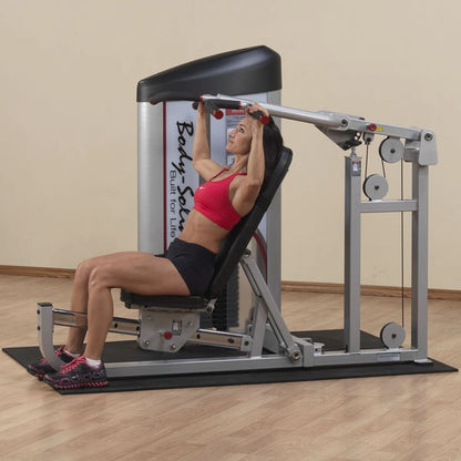 Woman using the Body-Solid Pro ClubLine Series 2 Multi-Press Machine S2MP for strength training in a gym setting.