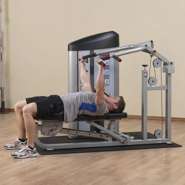 A person performing an exercise on the Body-Solid Pro ClubLine Series 2 Multi-Press Machine S2MP, lying on a bench and lifting weights.