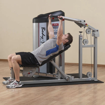 A person using the Body-Solid Pro ClubLine Series 2 Multi-Press Machine S2MP, performing a chest press exercise in a gym setting.