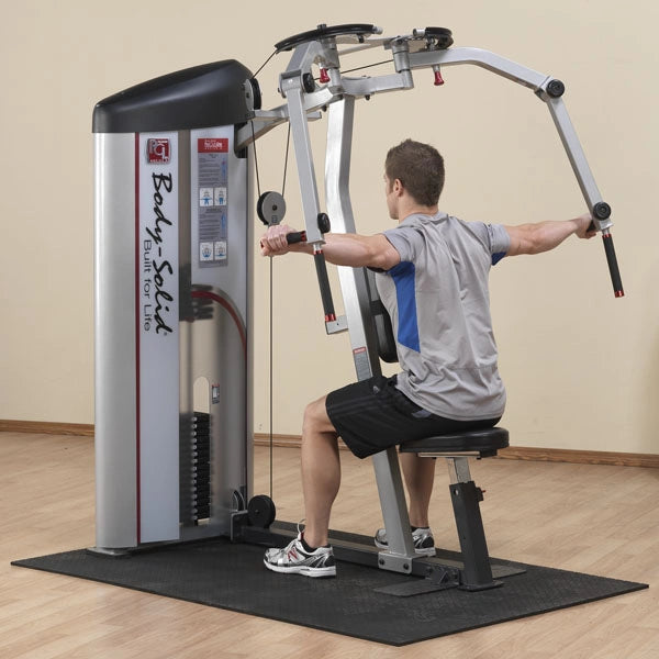A person using the Body-Solid Pro ClubLine Series 2 Pec Fly & Rear Delt Machine S2PEC in a gym setting, demonstrating proper exercise form while seated.
