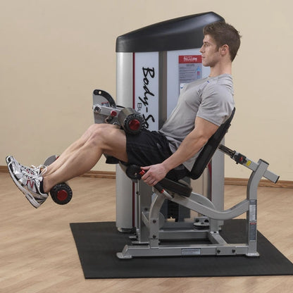 A man using the Body-Solid Pro ClubLine Series 2 Seated Leg Curl Machine S2SLC, demonstrating proper form while performing seated leg curls in a gym setting.