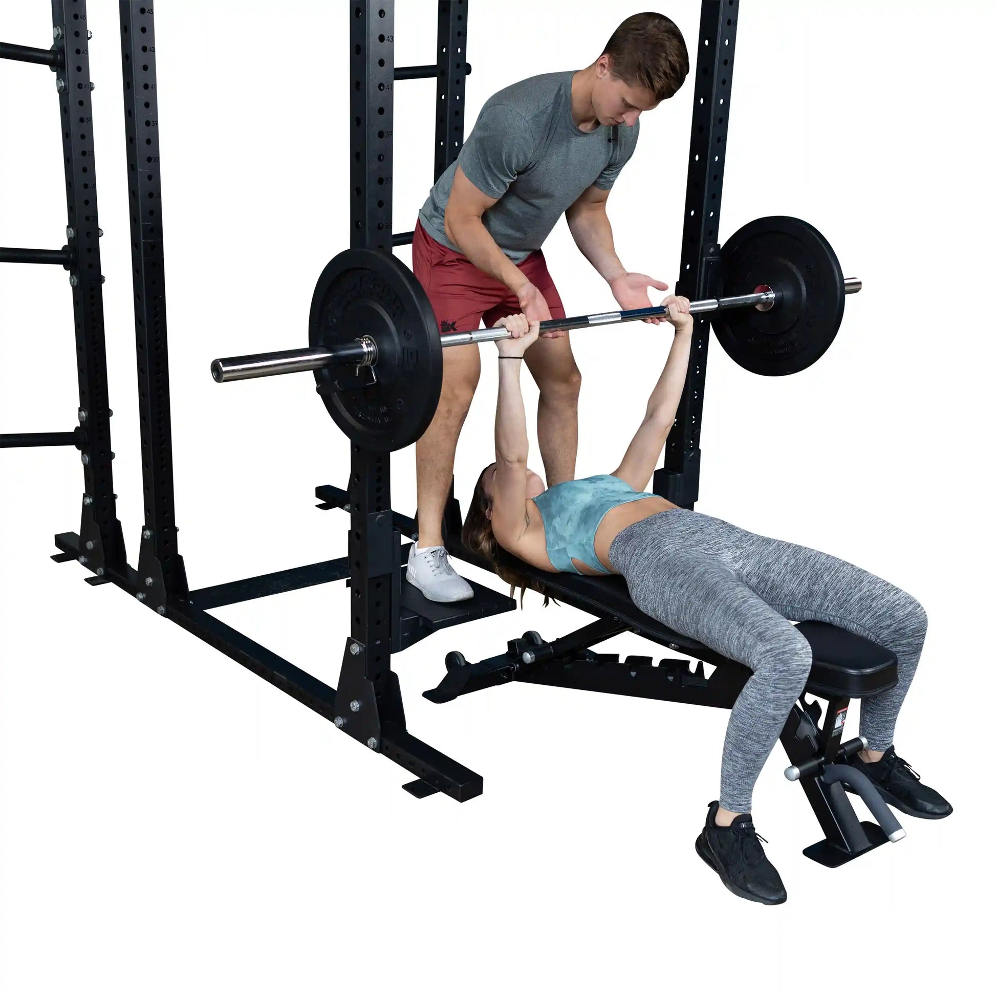 Two individuals using the Body-Solid Pro ClubLine Spotter Platforms SPRSP for a bench press workout, with one person spotting the other.