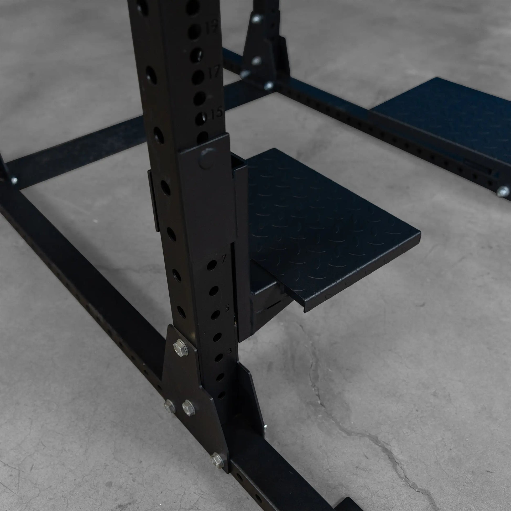 Close-up of the Body-Solid Pro ClubLine Spotter Platforms SPRSP, highlighting the textured foot platforms attached to the frame.