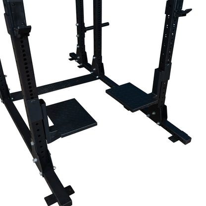 Close-up of Body-Solid Pro ClubLine Spotter Platforms SPRSP, featuring sturdy, textured black platforms integrated into a weightlifting rack for added safety and support during workouts.