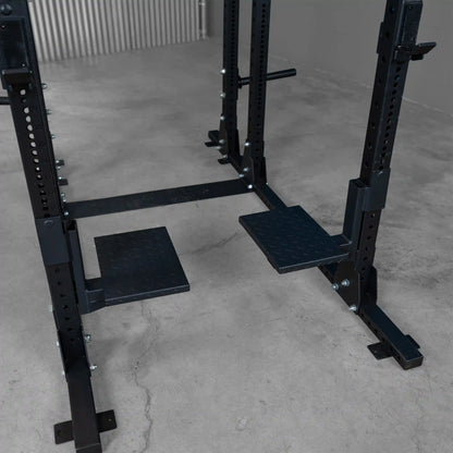 Body-Solid Pro ClubLine Spotter Platforms SPRSP mounted on a weight training rack with a solid black finish and textured non-slip surfaces for stability during workouts.