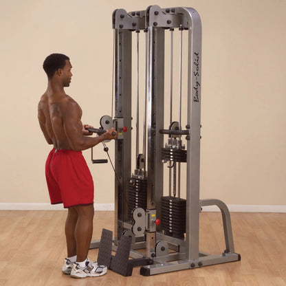 A person using the Body-Solid Pro Clubline Dual Cable Column SDC2000G2, performing an exercise with the cable machine in a gym setting.