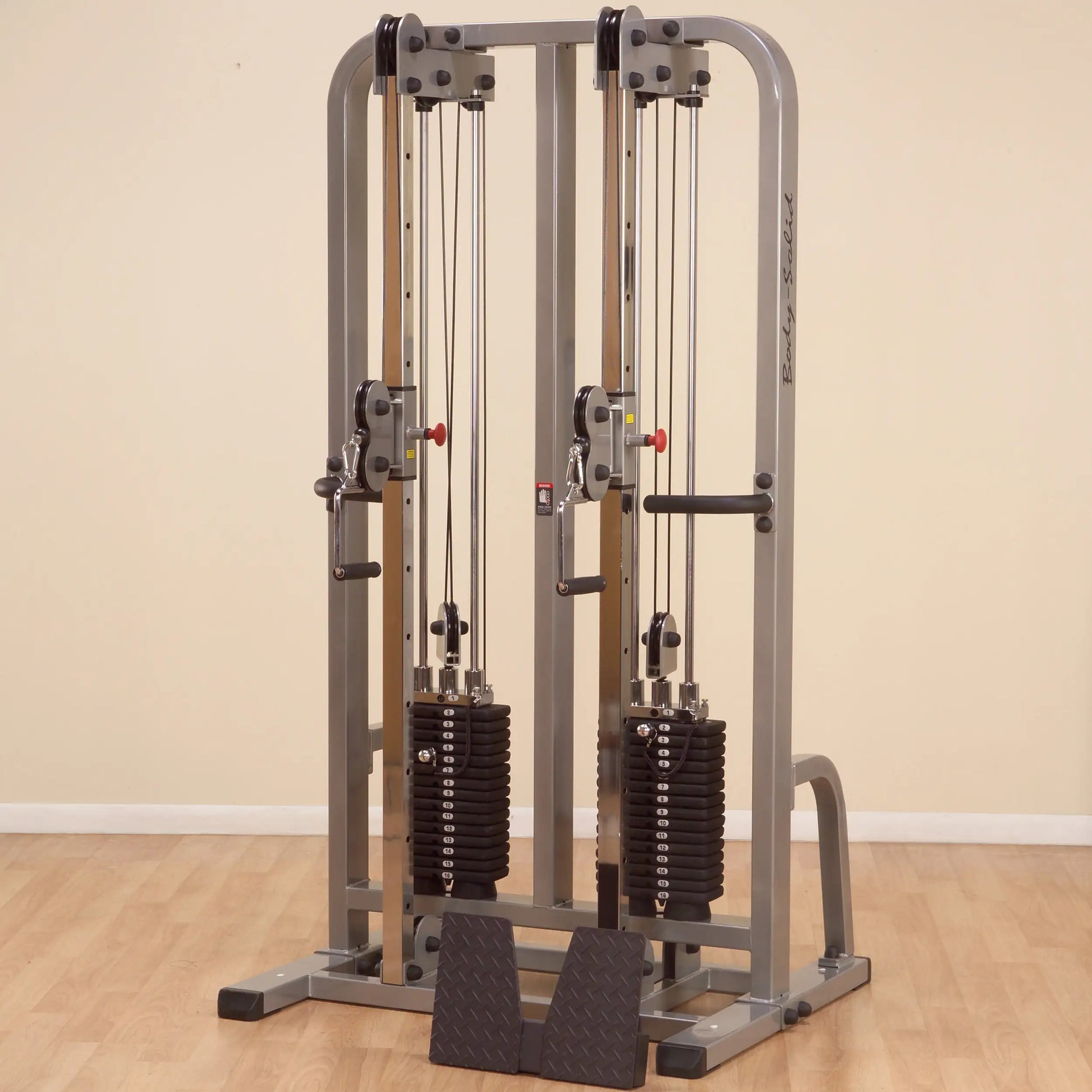 Body-Solid Pro Clubline Dual Cable Column SDC2000G2, a dual cable weight machine with adjustable pulleys and stacked weight plates, set against a neutral background.