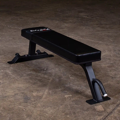 Body-Solid Pro Clubline Flat Bench SFB125 on a concrete floor, showcasing its sleek black design and sturdy frame.