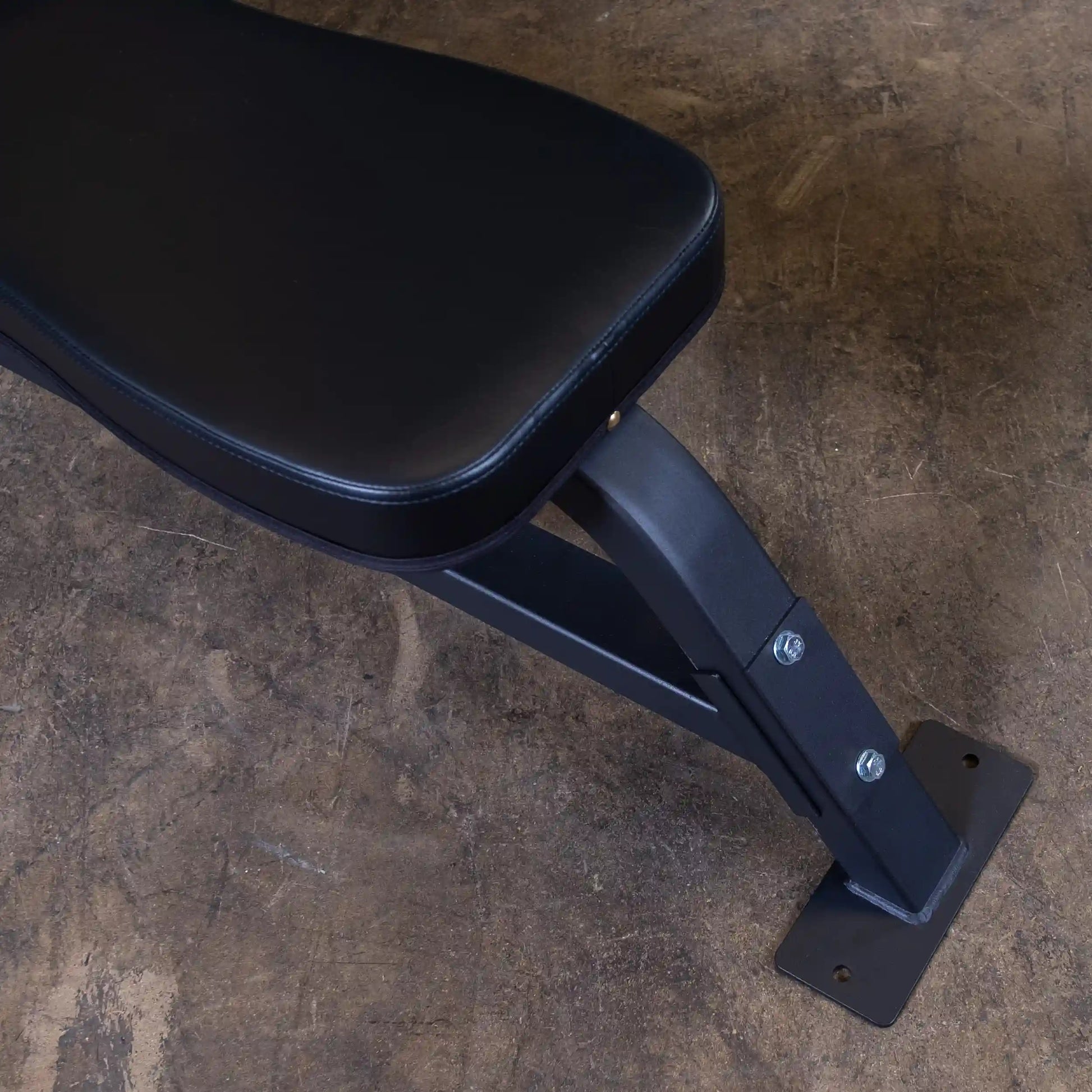 Close-up view of the Body-Solid Pro Clubline Flat Olympic Bench SOFB250, showcasing the sturdy black padded seat and robust metal frame.