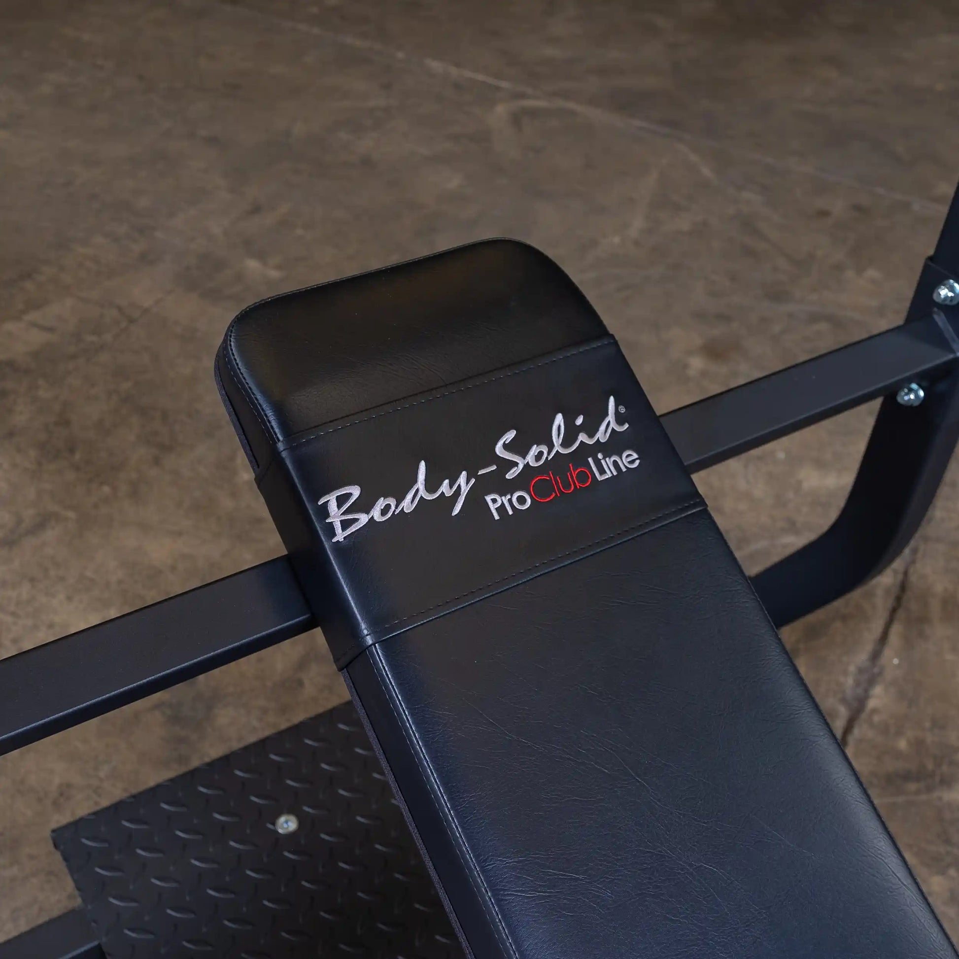 Close-up view of the Body-Solid Pro Clubline Incline Olympic Bench SOIB250, featuring a black padded seat with the Body-Solid logo.