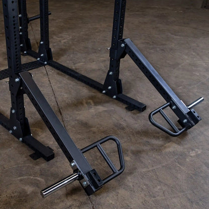 Body-Solid Pro Clubline Jammer Arms SPRJAM attached to a weightlifting rack, showcasing their sturdy design and functionality on a concrete floor.