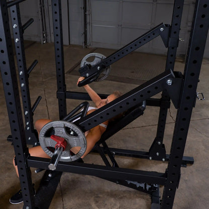 Woman exercising on Body-Solid Pro Clubline Jammer Arms SPRJAM in a gym setting.
