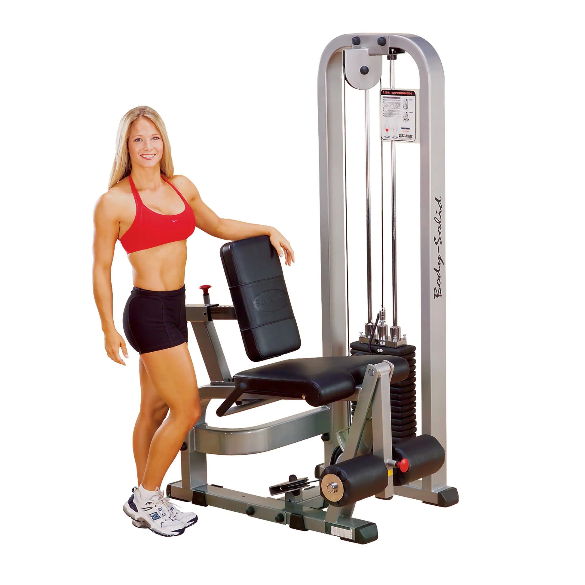 A fitness model demonstrating the Body-Solid Pro Clubline Leg Extension Machine SLE200G2, showcasing its design and features in a gym setting.