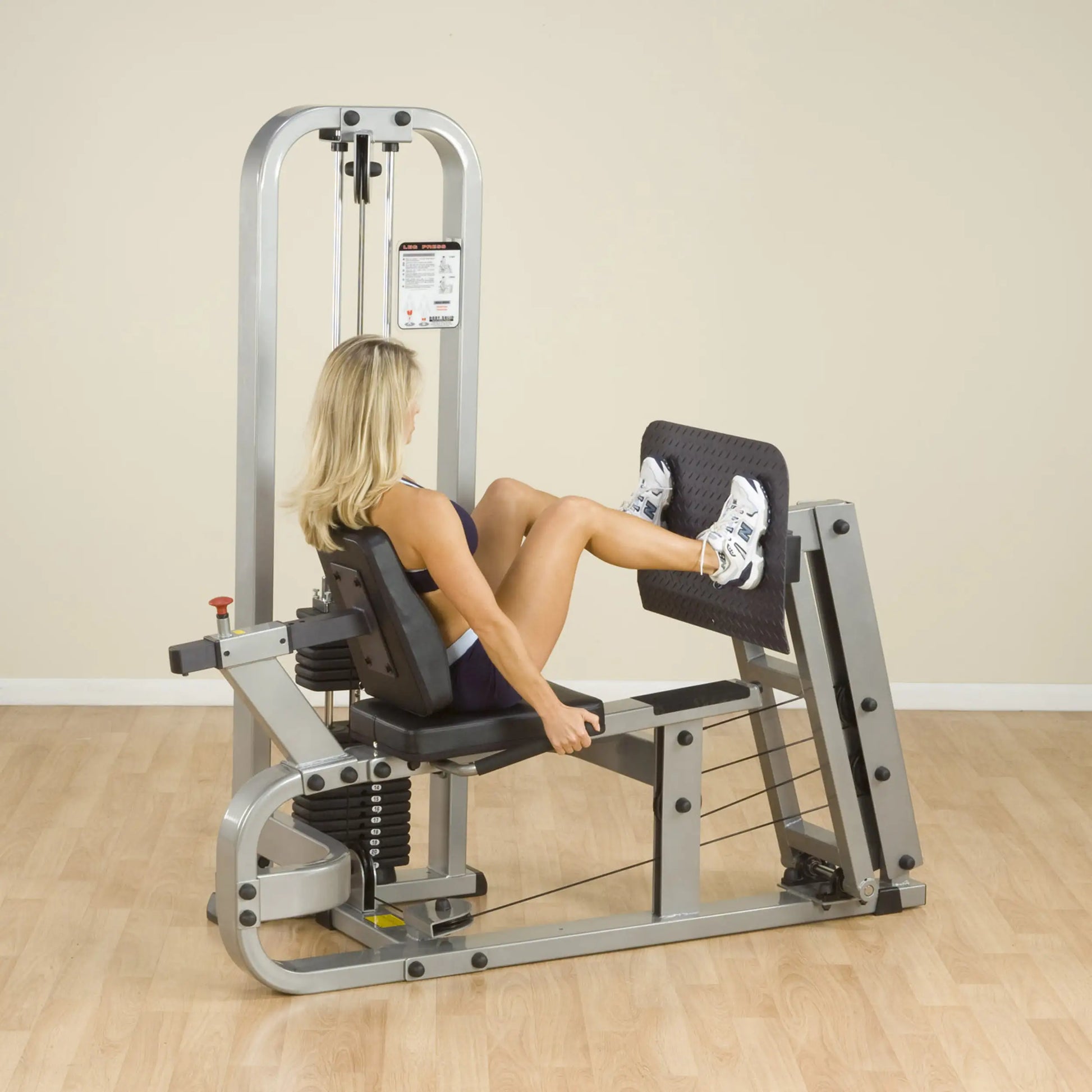 A person using the Body-Solid Pro Clubline Leg Press Machine SLP500G2 in a fitness setting, performing leg exercises.