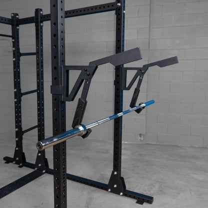 Body-Solid Pro Clubline Monolift Attachment SPRLFT mounted on a squat rack, showcasing a barbell resting securely in place, with a minimalist industrial backdrop.