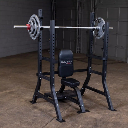 Body-Solid Pro Clubline Shoulder Olympic Bench SOSB250, featuring a sturdy frame with adjustable supports and a padded seat, displayed in a gym setting with weight plates on the barbell.
