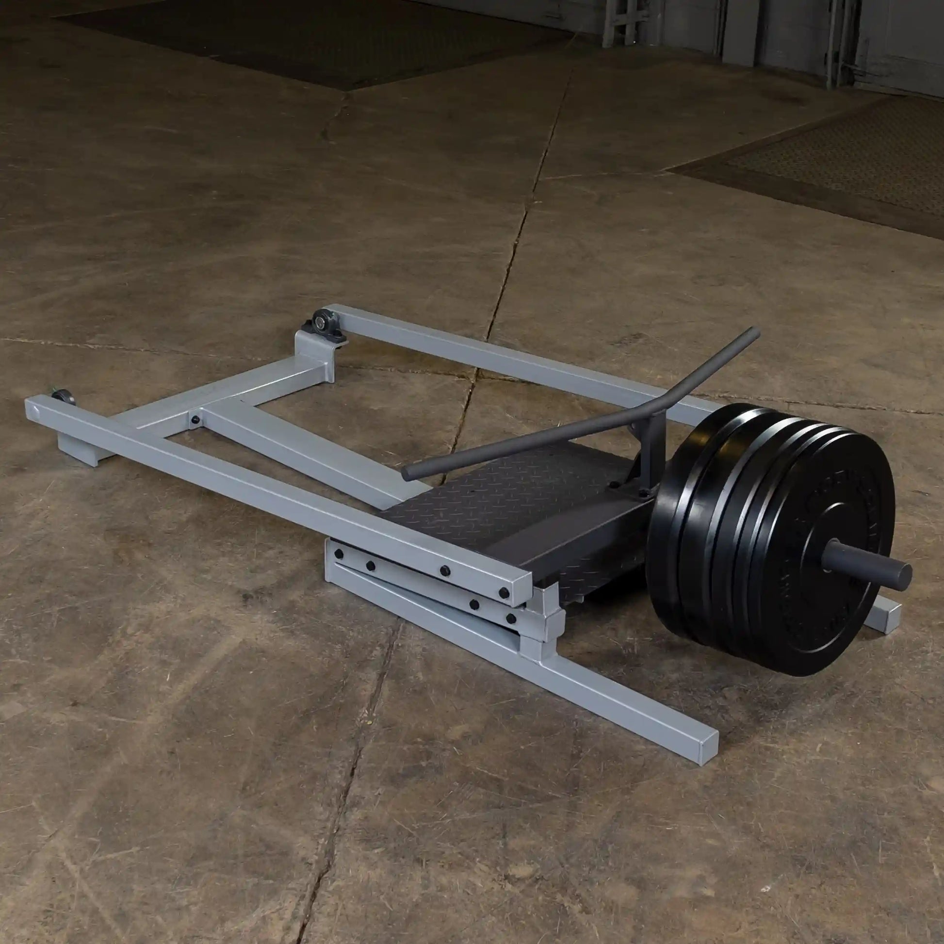 Body-Solid Pro Clubline T-Bar Row Machine STBR500 on a concrete floor, featuring a sturdy frame and weight plates.