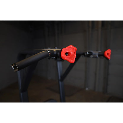 Close-up view of the Body-Solid Pro Clubline Vertical Knee Raise SVKR1000, featuring padded handles with red grips.