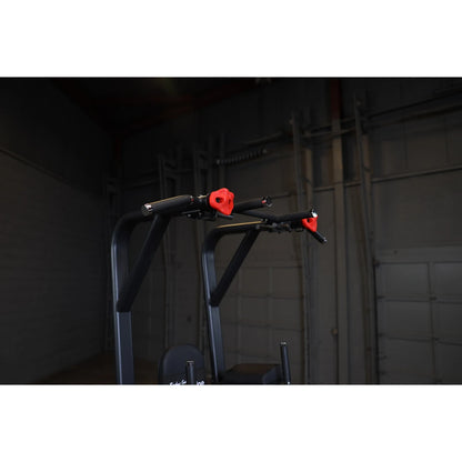 Close-up view of the Body-Solid Pro Clubline Vertical Knee Raise SVKR1000, showcasing its padded handles and frame design against a dark background.