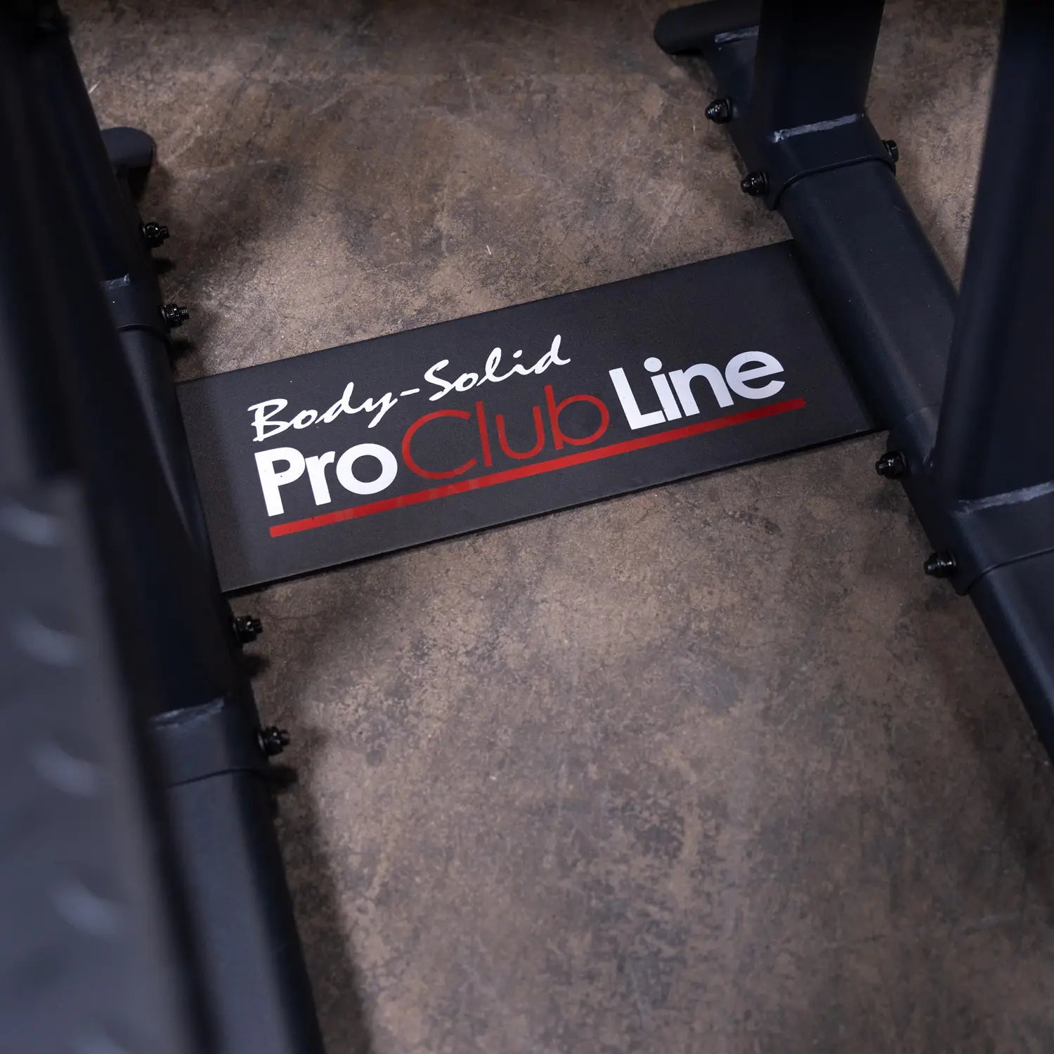 Image showing the logo of the Body-Solid Pro Clubline Vertical Knee Raise SVKR1000, prominently displayed on a black plate at the base of the equipment.