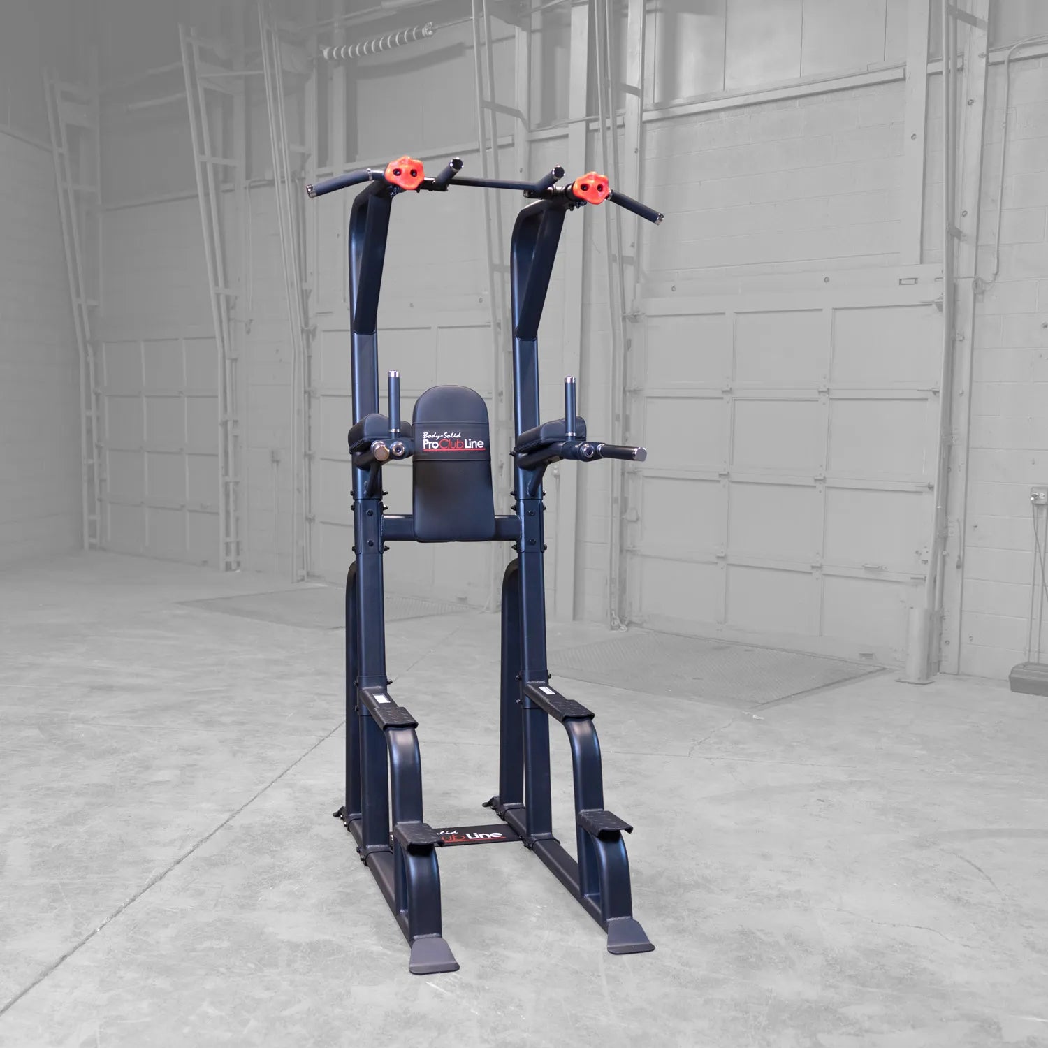 Body-Solid Pro Clubline Vertical Knee Raise SVKR1000, a sturdy exercise machine designed for vertical knee raises, positioned in a spacious gym environment.