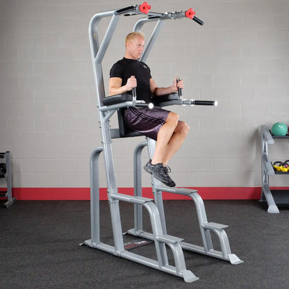 A man performing an exercise on the Body-Solid Pro Clubline Vertical Knee Raise SVKR1000, demonstrating proper form while using the machine in a gym setting.