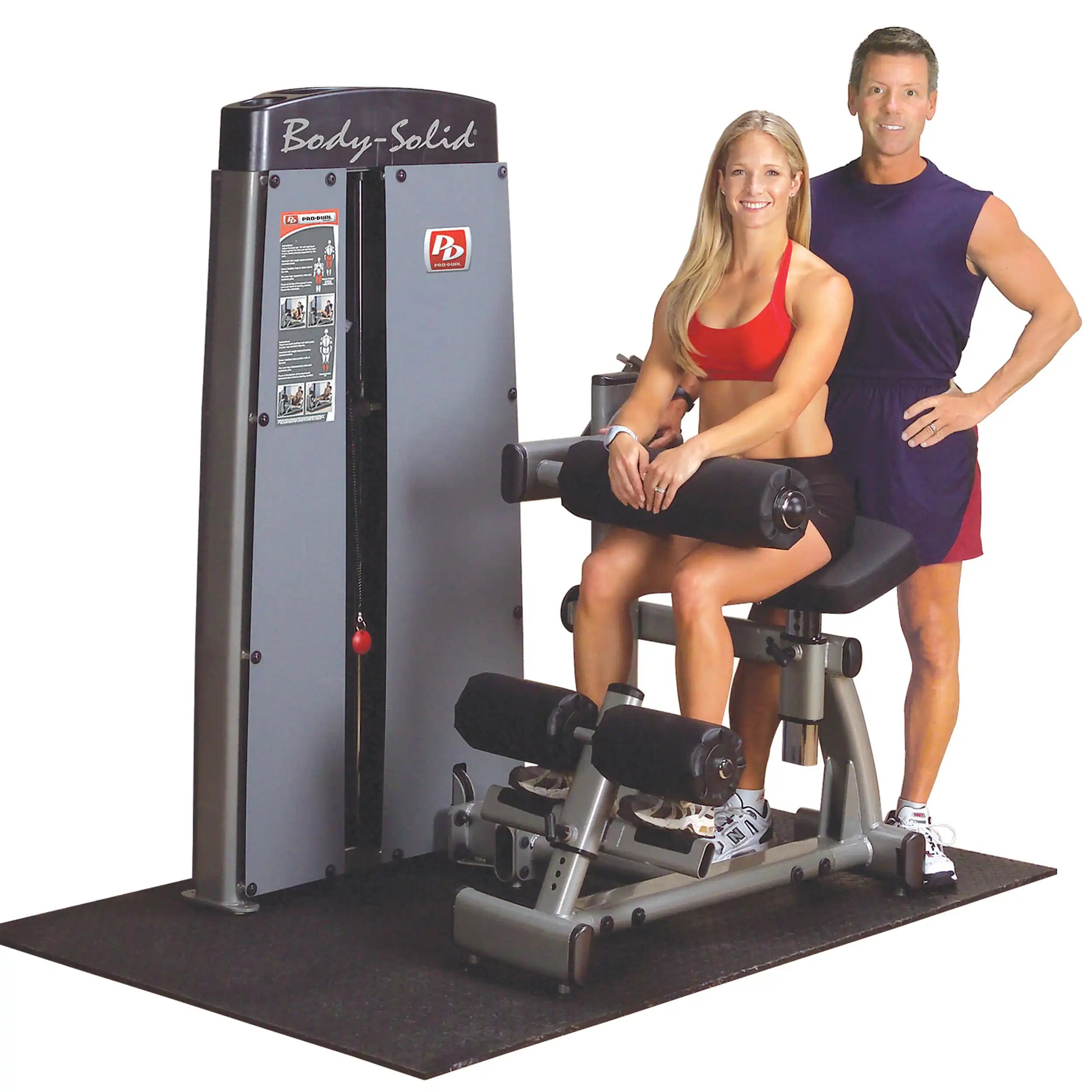 Body-Solid Pro Dual Ab & Back Machine DABBSF with a woman demonstrating its use and a man standing beside her, both in athletic attire.