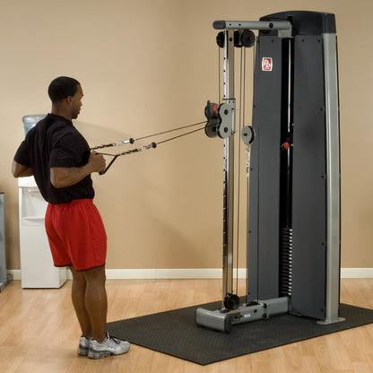 A person using the Body-Solid Pro Dual Cable Column Machine DPCCSF in a gym setting, performing a cable exercise with adjustable pulleys.