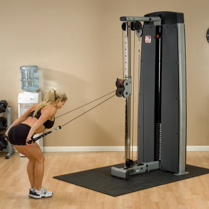 Woman performing an exercise using the Body-Solid Pro Dual Cable Column Machine DPCCSF in a gym setting.
