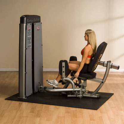 Woman using the Body-Solid Pro Dual Inner & Outer Thigh Machine DIOTSF in a gym setting, demonstrating leg exercises.