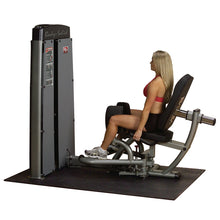 Woman using the Body-Solid Pro Dual Inner & Outer Thigh Machine DIOTSF in a gym setting, demonstrating the exercise equipment designed for inner and outer thigh workouts.