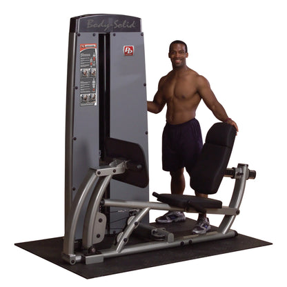 Body-Solid Pro Dual Leg & Calf Press Machine DCLPSF with a man standing beside it, showcasing the equipment designed for leg and calf exercises.