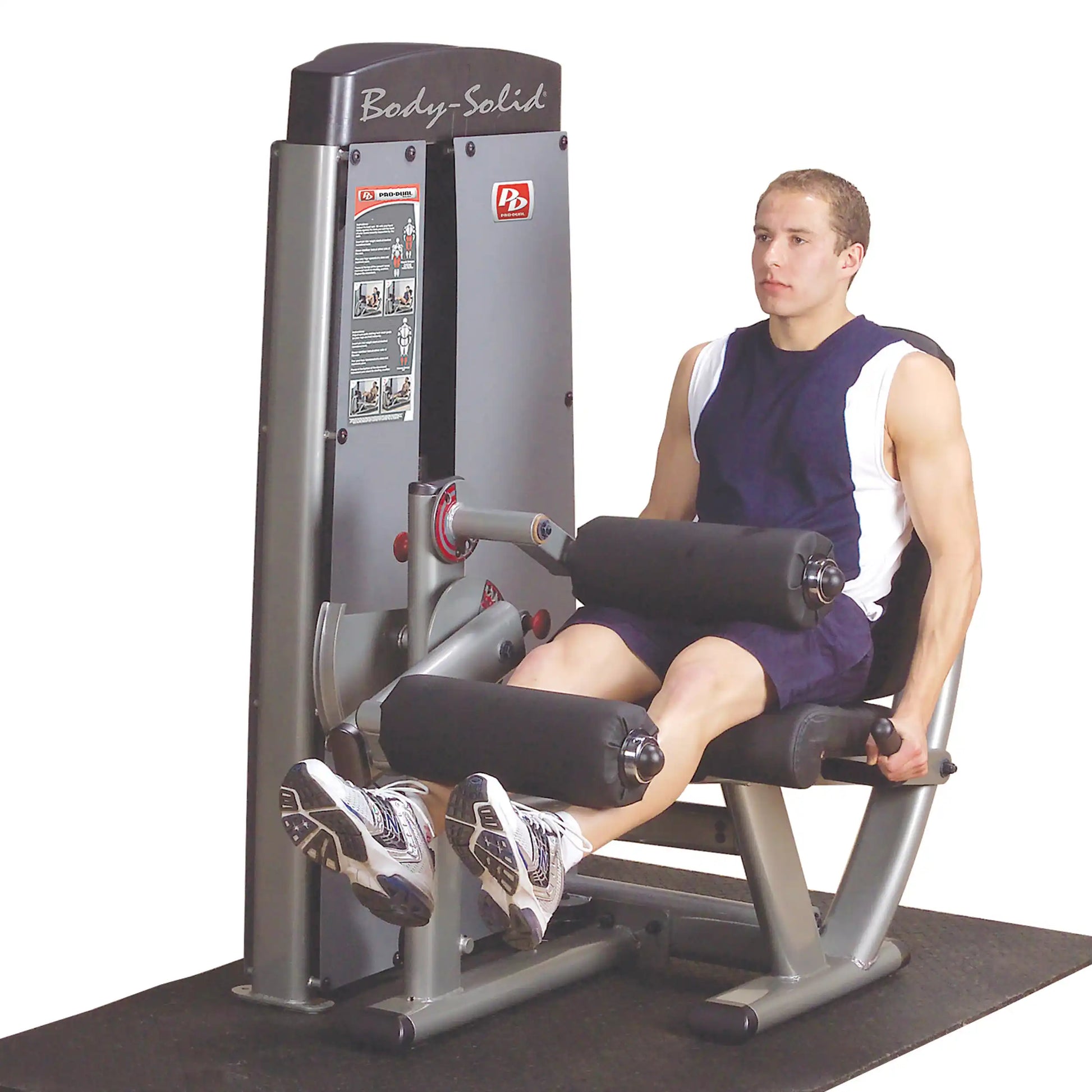 A person using the Body-Solid Pro Dual Leg Extension & Curl Machine DLECSF, demonstrating leg extension and curl exercises in a gym setting.