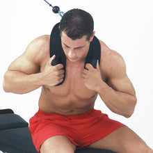 Man in red shorts using a neck harness for weight training.