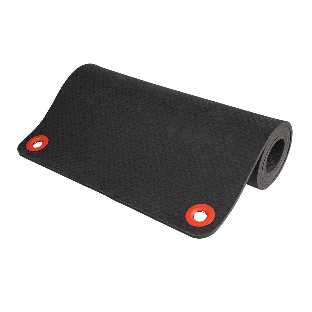 Black foam exercise mat with textured surface and red grommet eyelets at corners for hanging storage.
