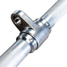 Stainless steel gym barbell with knurled grip and rotating sleeve.