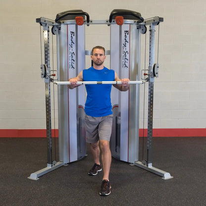 Man performing cable chest press on Body-Solid machine in gym, wearing blue shirt and gray shorts.